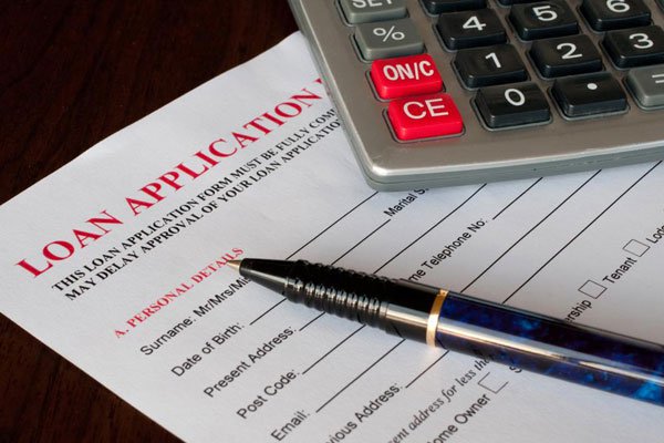 calculator, loan forms , pen